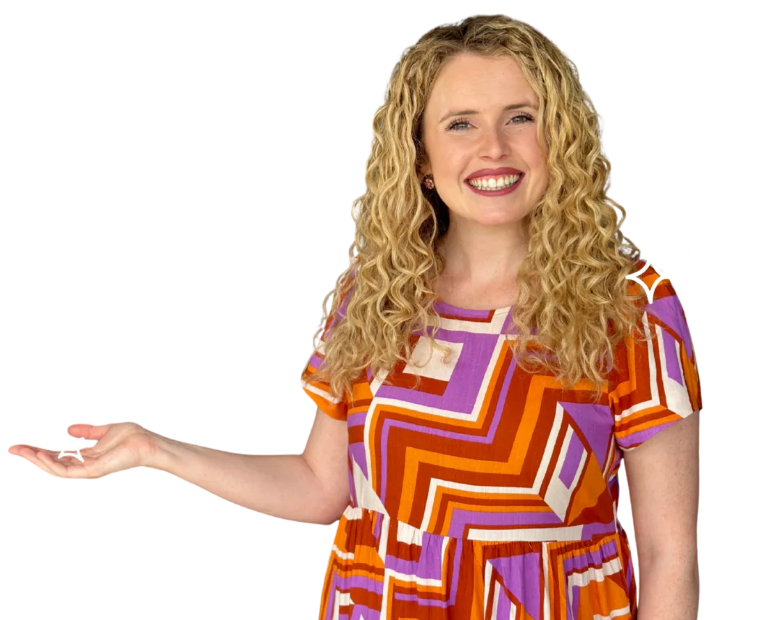 Dominique Solia, literacy and dyslexia specialist, smiling and gesturing in welcome